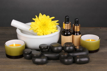 Spa setting on wooden table on grey background