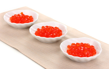 Red caviar in white bowls isolated on white