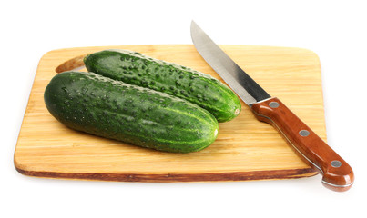 fresh cucumbers and knife on cutting board isolated on white