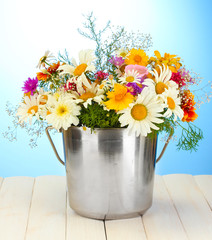 beautiful bouquet of bright  wildflowers in metal bucket,