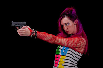 Punk girl shooting a pistol double handed.