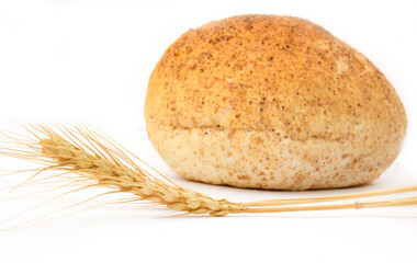 Wheat and bread on a white background