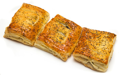 Three rolls with a poppy on a white background