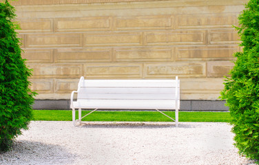 Empty bench on the wall background a sunny day