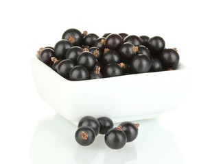 Fresh black currant in white bowl isolated on white