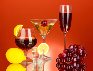 a variety of alcoholic drinks on red background