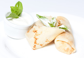 Pancakes with cottage cheese on a white plate.