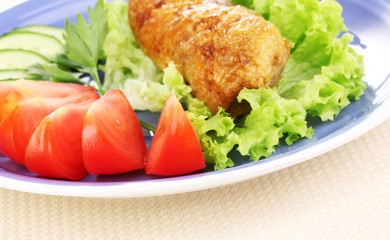 Tasty meat cutlet with garnish on plate