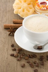 cup of coffee with beans and sweets
