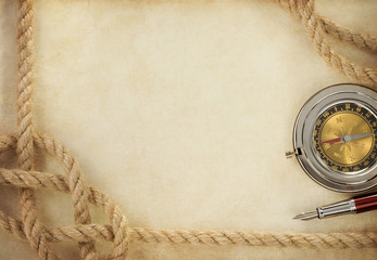 ropes and compass on old vintage ancient paper