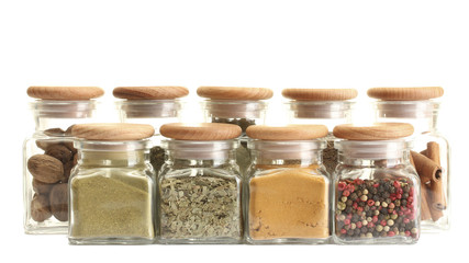 powder spices in glass jars  isolated on white