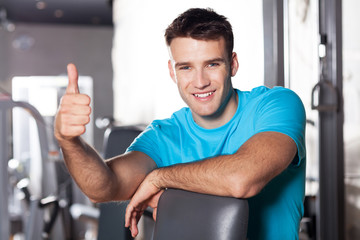 Man in health club showing thumbs up