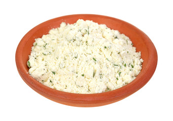 Powdered ricotta cheese with herbs in small bowl