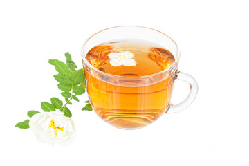 Hot tea with a flower of a jasmine and white dogrose