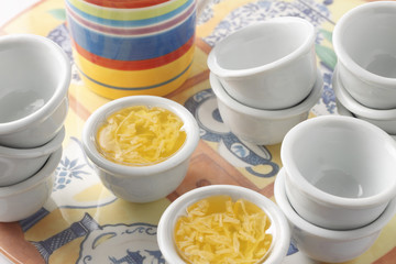 a group of thai jelly dessert with emypy cups on plate