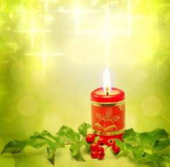 Christmas burning red candle and evergreen background