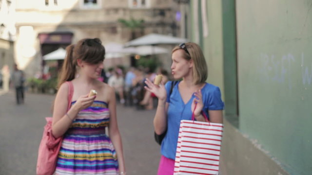 Happy female friends with shopping bags in the city