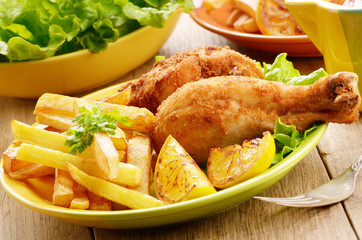 Fried drumsticks with french fries