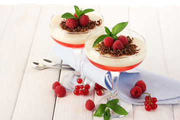 fruit jelly with berries in glasses on wooden table