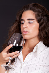 woman smelling a glass of wine
