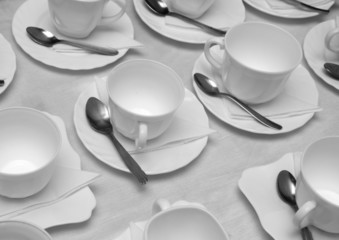 Plastic cups and saucers with spoons