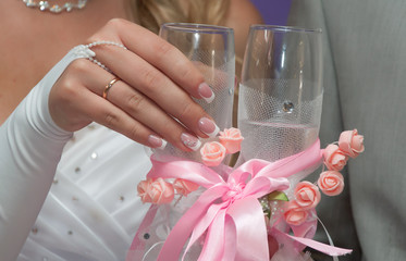 Bride holds a glass with champagne