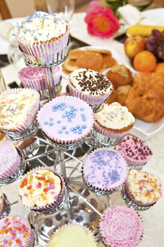 Variety of decorated cupcakes on breakfast table