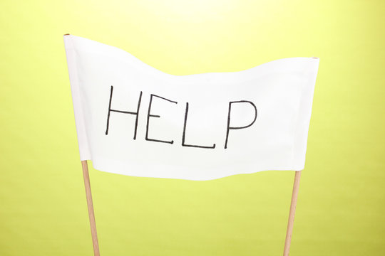 Fototapeta Help written on white cloth on green background