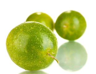 three green passion fruit isolated on white