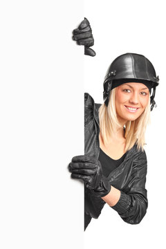 A Portrait Of A Smiling Female Motorcyclist Holding A Blank Pane