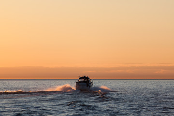 Motor boat sunset silhouette