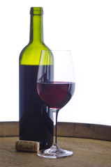 Glass of Red Wine By a Bottle Isolated on White