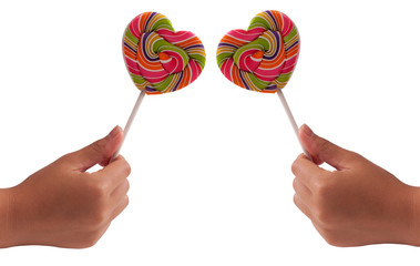 two hand holding lollipop in shape of heart