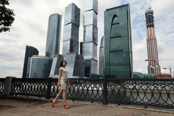 Naklejka premium Walking sexy woman in Moscow City