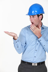 Surprised engineer looking at his palm