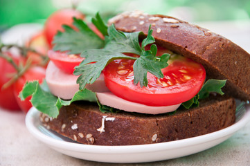 Healthy ham sandwich with  tomatoes and lettuce