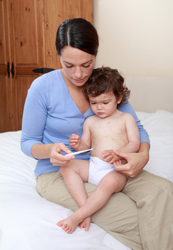 Mum Taking Ill Babies Temperature