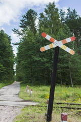 Railway crossing sign in forest