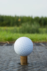 Golf ball with rubber tee