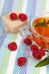 Tea with raspberries,waffles and mint