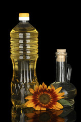 sunflower oil in a plastic bottle and small decanter isolated