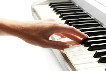 hand of woman playing synthesizer