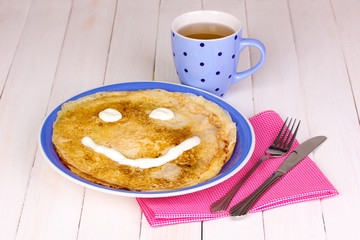 Stack of tasty pancakes on wooden background