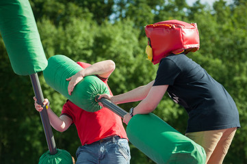 children fighting with foam clubs