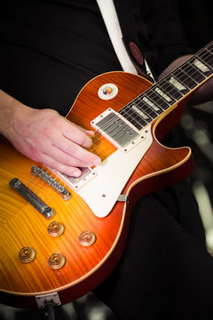 close-up of a musician playing an electric guitar