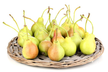 ripe pears on wicker mat isolated on white.
