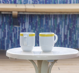 Two Coffee Cups on White Table