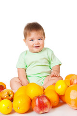 Fototapeta na wymiar Smiling baby sitting with fruit