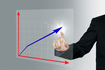 Business man pointing a growing graph on the screen background