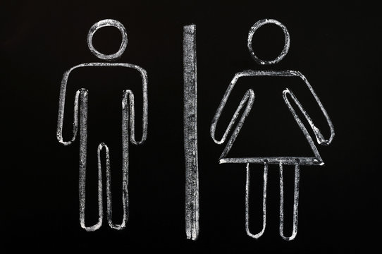 Men and women symbols drawn on blackboard background